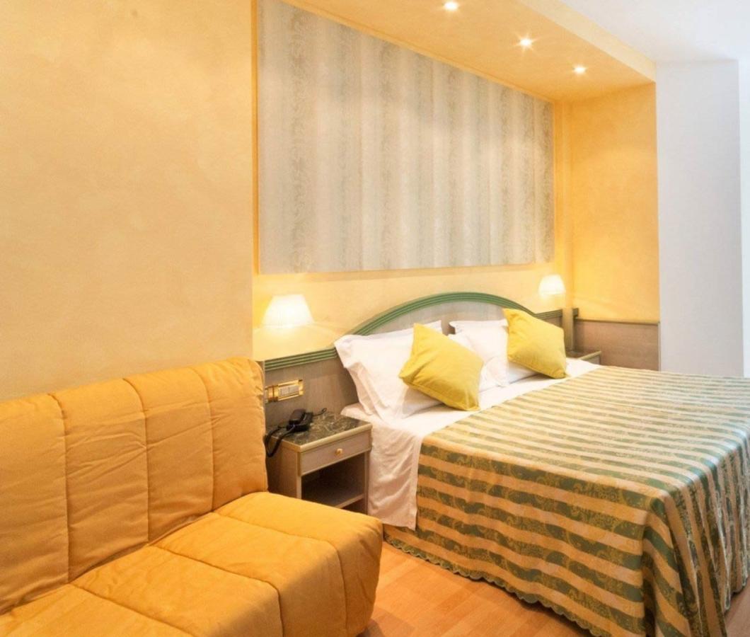 Camera d'hotel accogliente con letto matrimoniale e arredi moderni.