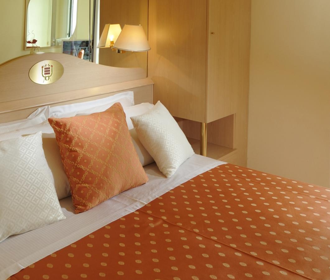 Camera d'hotel con vista mare e balcone.