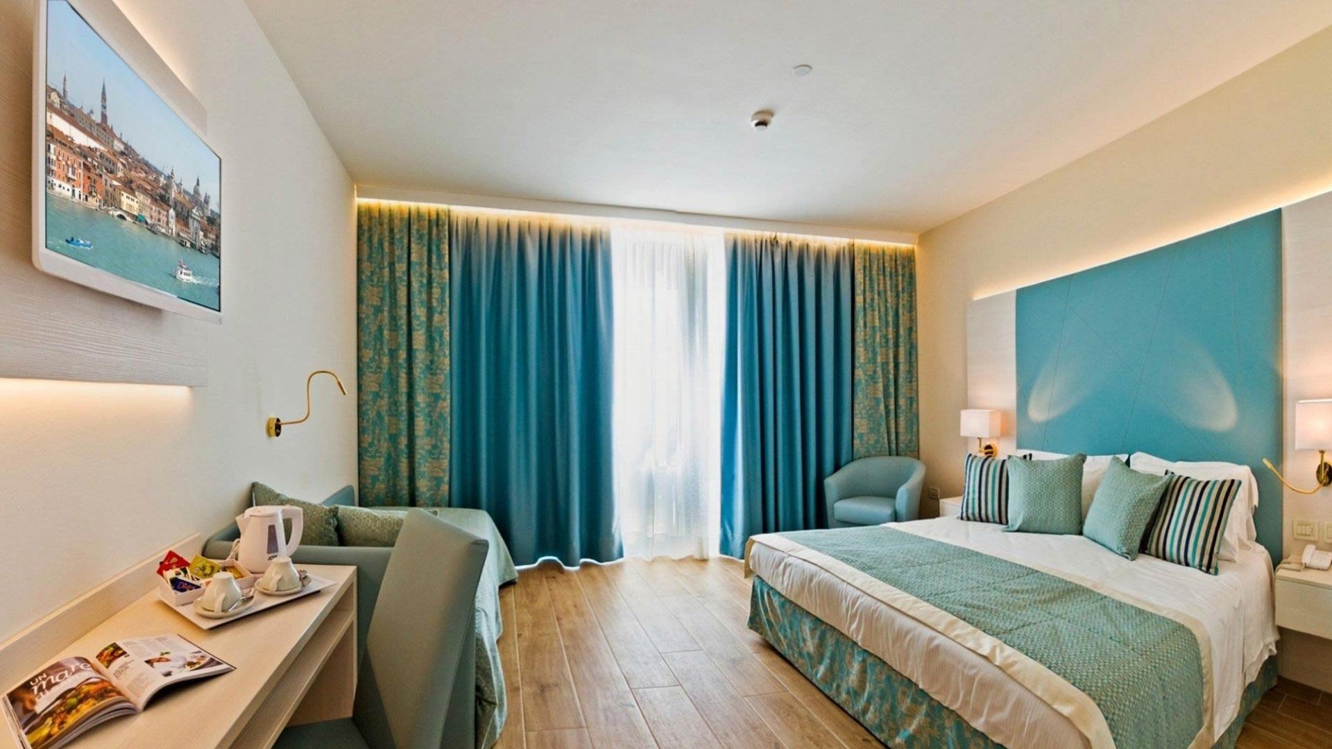 Camera d'albergo moderna con decorazioni blu e mobili eleganti.