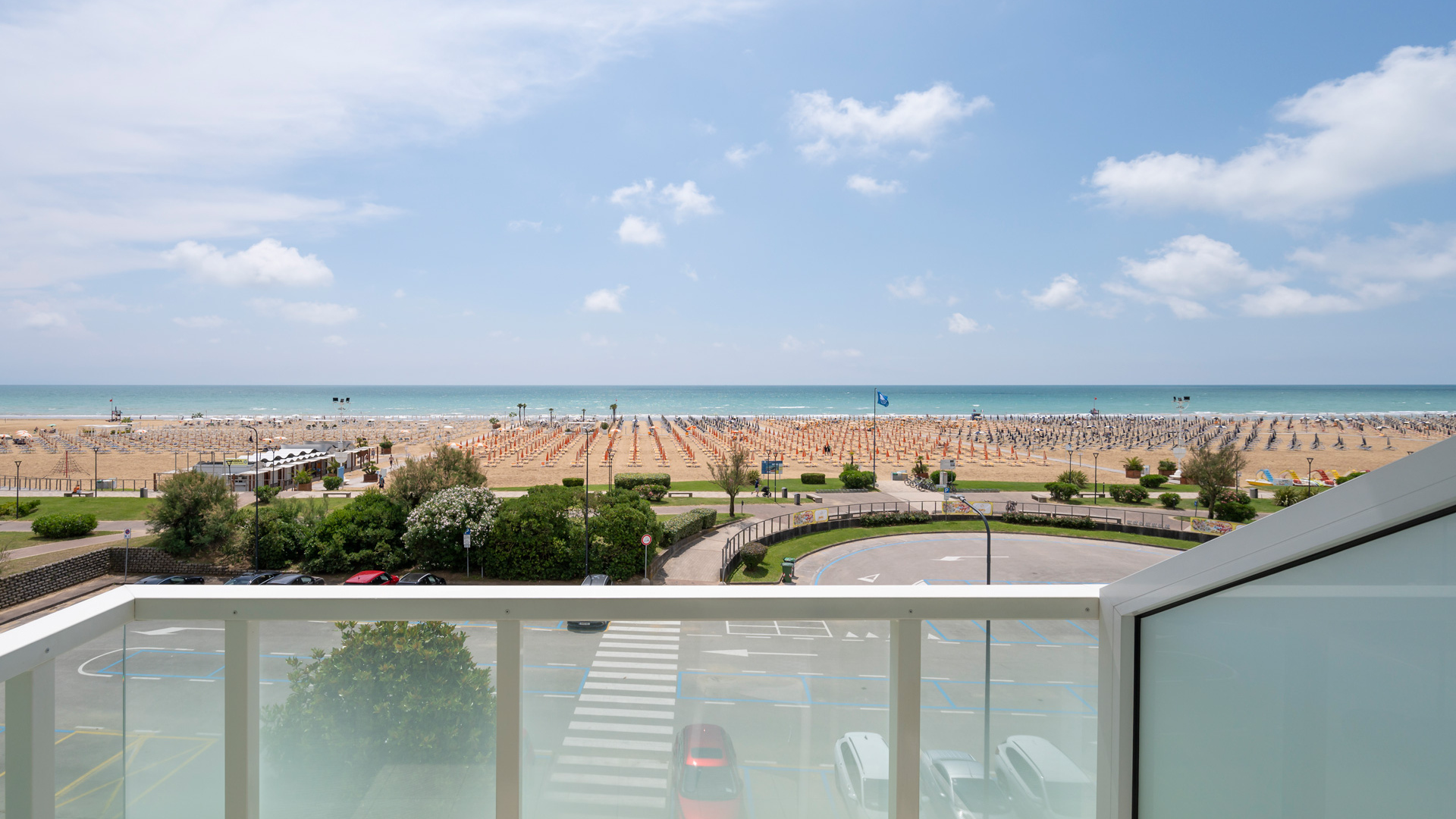 Sea view with beach and umbrellas, clear sky.
